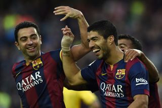 Xavi and Luis Suarez celebrate a Barcelona goal against Getafe in April 2015.