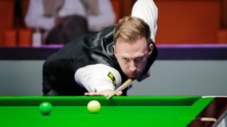 Judd Trump of England plays a shot ahead of the UK Championship snooker tournament 