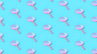 A repeating pattern of pink magnifying glasses on a light blue background