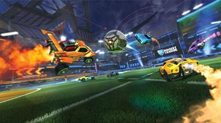 Rocket League screenshot of three cars in a game mode, zooming toward the hovering ball in the center of the screen