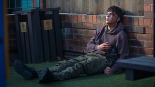 Mason Radcliffe lies on the floor with a head wound after being stabbed in Coronation Street.