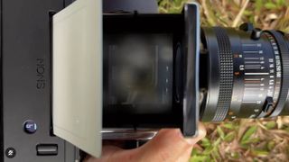 A Hasselblad 503cx with a Nons instant film back spits out instant film