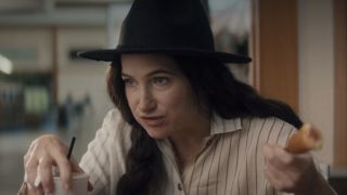 Agatha Harkness (Kathryn Hahn) eats a corn dog on Agatha All Along