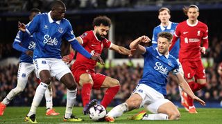 Mohamed Salah is tackled by Abdoulaye Doucoure and James Tarkowski in the previous Everton vs Liverpool Premier League match at Goodison Park in 2024.