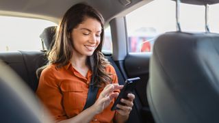 Woman looking at her phone in the car