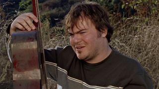 Screenshot of Jack Black being sad while looking at his guitar in Tenacious D