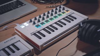 An Arturia MIDI keyboard controller on a desktop in a studio