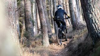 A mountain biker riding a cross-country mountain bike