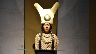 Reconstructed bust of Senora de Cao showing her with medium brown skin, dark brown hair, and a fancy headdress