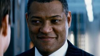 Laurence Fishburne smiles as he talks with Tom Cruise in Mission: Impossible III.