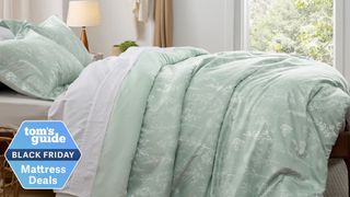 Green floral bedding on a bed in a well-lit bedroom