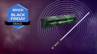 A Star Wars The Black Series Sabine Wren Force FX Elite Electronic Lightsaber, with its box, next to a Space Black Friday Deals logo. 