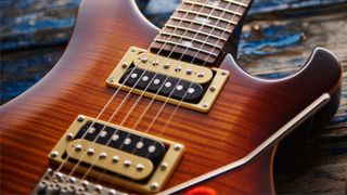 Close up of a PRS SE Custom 24 on a wooden floor