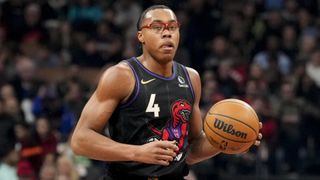 Toronto Raptor Scottie Barnes dribbles the basketball in his no.4 black vest.