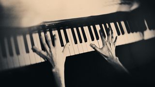 Overheard shot of hands on a piano