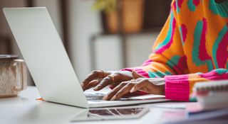 A person using a laptop keyboard