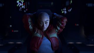 Jodran A. Mun leans back in the cockpit of her spaceship, arms behind her head, in an Intergalactic: The Heretic Prophet PS5 screenshot