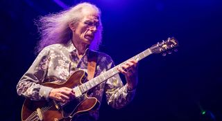 Steve Howe of Yes wears a floral patterned shirt as he plays his Gibson ES-345 semi-hollow live with Yes.