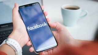 Facebook logo on a phone display