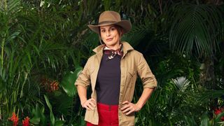 Coleen Rooney dressed in khakis and posing in front of some leaves ahead of her appearance in I&#039;m a Celebrity 2024.