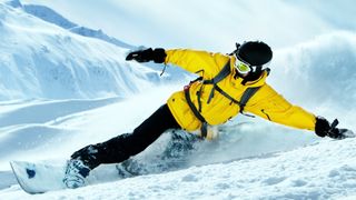 man snowboarding on mountain in India 