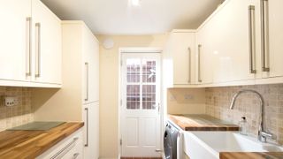 White slab kitchen with wooden worktops