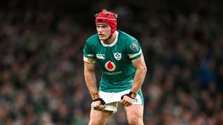 Josh van der Flier of Ireland, wearing a red head guard, grimaces ahead of the Ireland vs Australia final match of the Autumn Internationals series 2024-2025 