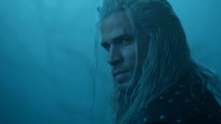 The Witcher - Liam Hemsworth first look as Geralt of Rivia wears a white wig with yellow eyes.