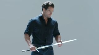 Henry Cavill holding a sword