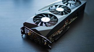 A graphics card on a wooden table in shadow