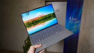 Asus Zenbook A14 held in a person&#039;s hand at CES 2025