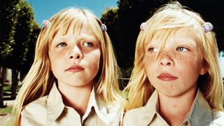 a photo of two twin girls with blond hair and freckles