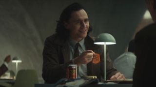 Tom Hiddleston points in conversation with an inspired smile on his face in Loki - S1 E2 The Variant.