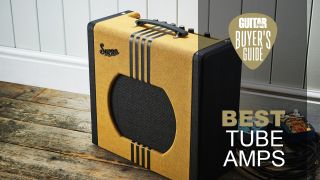 Orange and Black Supro Delta King 12 amp on a wooden floor in front of a white wood-paneled wall