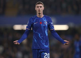 Cole Palmer Chelsea winger forward midfielder with his arms outstretched as he plays at Stamford Bridge in the Premier League