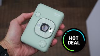 The Instax Mini Liplay camera held in a person&#039;s hands