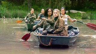 Lena, Dr. Ventress, Josie, Anya and Cass in two rowing boats paddling along the river.