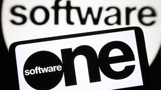 SoftwareOne logo and branding pictured on a smartphone screen in black and white lettering with &#039;software&#039; blurred in background.