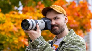 Photographer Dan Mold shooting outside on an autumnal day with the Canon EOS R5 Mark II and RF 70-00mm F2.8L IS USM hybrid lens