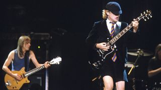 Brothers Malcolm Young and Angus Young of AC/DC perform on stage at Melbourne Park on February 11th 2001 in Melbourne, Australia