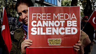 Protesters in Istanbul, Oct. 28, 2015. Close up of a red placard reading &#039;Free media cannot be silenced&#039;