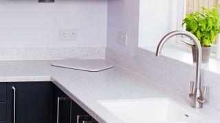 Light stone effect Corian worktop in contemporary kitchen