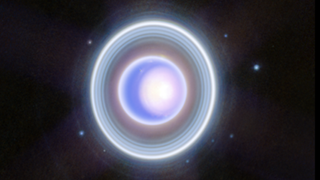 a bright blue-white orb surrounded by many white concentric rings 