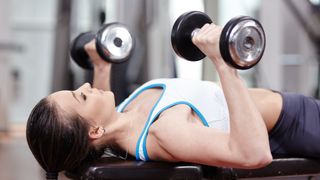 woman doing dummbell chest press