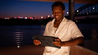 A man smiling as he gazes into the yawning abyss of his massive Acer Nitro Blaze 11.