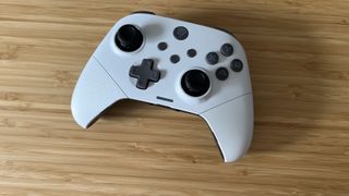 EasySMX X10 controller in white on a wooden table