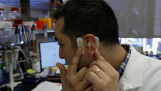 A close-up of a man wearing a device in his ear