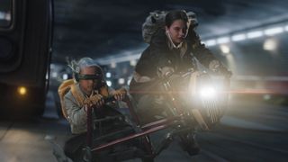 KB and Fern fly through the air on a hover bike at night in Star Wars: Skeleton Crew