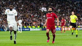 Mohamed Salah (R) and Antonio Rudiger (L) run after the ball during the last Liverpool vs Real Madrid clash in the UEFA Champions League in 2023