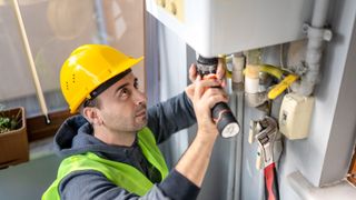 Private technician repairing combi gas boiler